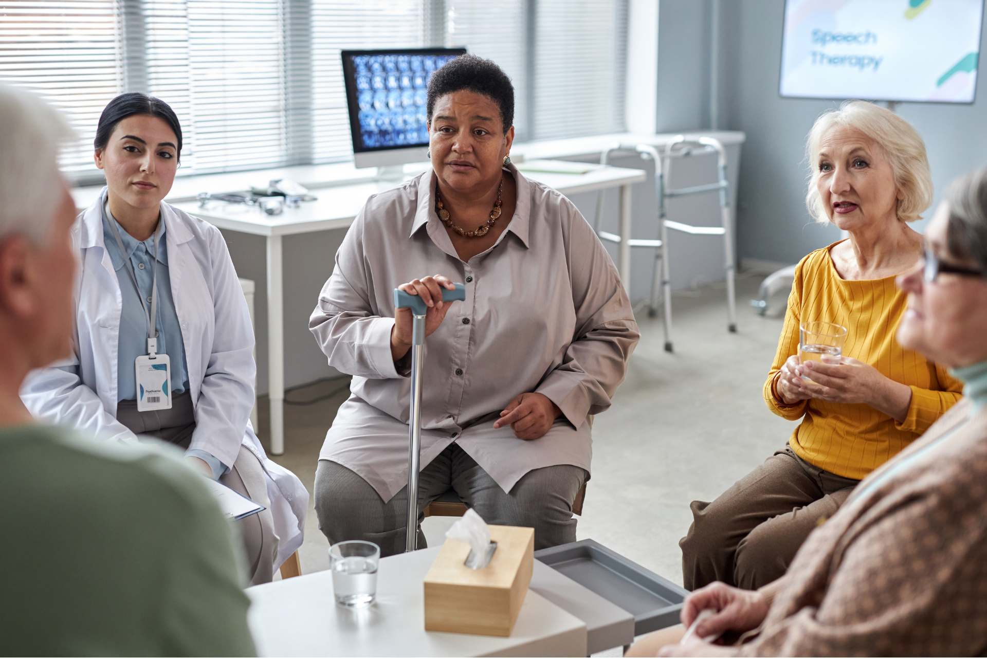 Senior women sit together at a doctors office talking to their doctors